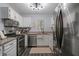 Efficient kitchen with modern appliances, granite countertops and white cabinetry at 401 Berkeley Woods Dr, Duluth, GA 30096