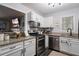 Bright kitchen with granite countertops, stainless steel appliances, and ample storage at 401 Berkeley Woods Dr, Duluth, GA 30096