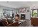 Cozy living room features a fireplace, hardwood floors, and large windows for natural light at 401 Berkeley Woods Dr, Duluth, GA 30096