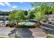 Aerial view of a community pool surrounded by trees, buildings, and parking at 401 Berkeley Woods Dr, Duluth, GA 30096