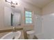 Bathroom featuring a tub and shower combo with a window at 6141 Windsong Way, Smoke Rise, GA 30087