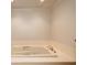 Bathroom featuring a large soaking tub, tile flooring, and modern fixtures at 6141 Windsong Way, Smoke Rise, GA 30087