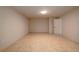 A bedroom with tile floors, neutral walls, and a standard-sized door leading out to another room at 6141 Windsong Way, Smoke Rise, GA 30087