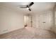 Bedroom with a ceiling fan, spacious closet and view to another room at 6141 Windsong Way, Smoke Rise, GA 30087