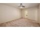 Carpeted bedroom with a modern ceiling fan, window view, and neutral paint at 6141 Windsong Way, Smoke Rise, GA 30087