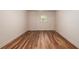 A modest bedroom features wood laminate flooring and a window providing natural light at 6141 Windsong Way, Smoke Rise, GA 30087