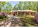 Charming brick home with a welcoming front porch and lush landscaping at 6141 Windsong Way, Smoke Rise, GA 30087