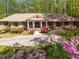 Well-maintained brick home featuring a symmetrical facade and beautiful landscaping at 6141 Windsong Way, Smoke Rise, GA 30087