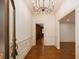 Grand foyer featuring hardwood floors, decorative molding, and a stylish chandelier at 6141 Windsong Way, Smoke Rise, GA 30087