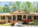 Lovely brick home with a columned porch and manicured flowerbeds at 6141 Windsong Way, Smoke Rise, GA 30087