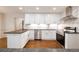 Modern kitchen featuring white cabinets, stainless steel appliances, and a tile backsplash at 6141 Windsong Way, Smoke Rise, GA 30087