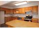 Well-equipped kitchen featuring stainless steel appliances, wooden cabinets, and a center island at 6141 Windsong Way, Smoke Rise, GA 30087