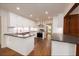 Bright kitchen with marble backsplash, stainless steel appliances, and dark countertop at 6141 Windsong Way, Smoke Rise, GA 30087