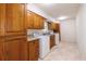 Spacious laundry room with ample cabinet storage and utility sink at 6141 Windsong Way, Smoke Rise, GA 30087