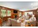 Spacious living room with hardwood floors, a wood burning fireplace, and built in cabinetry at 6141 Windsong Way, Smoke Rise, GA 30087