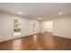 Bright living room with hardwood floors, wainscoting, and abundant natural light at 6141 Windsong Way, Smoke Rise, GA 30087