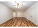 Spacious living room featuring new laminate wood flooring and ceiling fan at 6141 Windsong Way, Smoke Rise, GA 30087