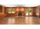 Living room with hardwood floors features a fireplace and built-in shelving providing plenty of storage space at 6141 Windsong Way, Smoke Rise, GA 30087