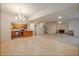Open concept living space with kitchen, stairs, and fireplace features both carpet and tile at 6141 Windsong Way, Smoke Rise, GA 30087