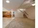The open living space has tile flooring, a brick fireplace, a kitchen area, and a staircase at 6141 Windsong Way, Smoke Rise, GA 30087