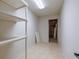 This storage room has built-in shelving and a door leading to an unfinished area at 6141 Windsong Way, Smoke Rise, GA 30087