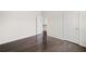 An empty bedroom with dark wood floors and white walls at 327 Morning Frost, Canton, GA 30114