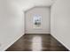 Small bedroom with dark hardwood floors, small window, and neutral colored walls at 327 Morning Frost, Canton, GA 30114