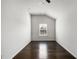 Bright bedroom with dark hardwood floors and a window letting in natural light at 327 Morning Frost, Canton, GA 30114