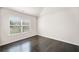 Bedroom with dark hardwood floors and a window letting in natural light at 327 Morning Frost, Canton, GA 30114