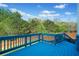 Exterior of the home, showing a bright blue wooden deck overlooking a lovely backyard at 327 Morning Frost, Canton, GA 30114
