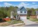 Beautiful two-story home with a brick facade, blue accents, and a well-manicured lawn at 327 Morning Frost, Canton, GA 30114