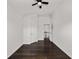 Hardwood hallway with white doors and open stairway at 327 Morning Frost, Canton, GA 30114