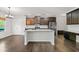 Modern kitchen with an island, stainless steel appliances, and dark wood cabinets at 327 Morning Frost, Canton, GA 30114