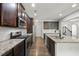 Well-equipped kitchen with stainless steel appliances, granite countertops, and dark wood cabinetry at 327 Morning Frost, Canton, GA 30114