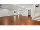 Spacious living room with hardwood floors, white walls, and a staircase at 327 Morning Frost, Canton, GA 30114