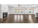 Open-concept living room with hardwood floors, fireplace, and ample natural light at 327 Morning Frost, Canton, GA 30114