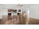 Open-concept living space with kitchen island and hardwood floors throughout at 327 Morning Frost, Canton, GA 30114