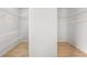 Spacious walk-in closet with white wire shelving and light wood floors at 327 Morning Frost, Canton, GA 30114