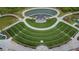 Beautiful aerial view of an outdoor amphitheater, stage, and surrounding green space with a pond and walkways at 4915 Bergen Ct, Cumming, GA 30040