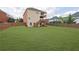Expansive backyard with a large, well-maintained lawn and wooden fence, perfect for outdoor activities at 4915 Bergen Ct, Cumming, GA 30040
