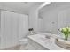 Bright bathroom with white shower curtain, toilet, sink and vanity at 4915 Bergen Ct, Cumming, GA 30040