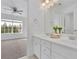 Bright bathroom featuring double sinks, white cabinets and a serene view at 4915 Bergen Ct, Cumming, GA 30040
