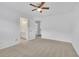 Bright bedroom featuring neutral carpet, a ceiling fan, and an ensuite bathroom at 4915 Bergen Ct, Cumming, GA 30040