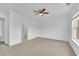 Spacious bedroom with neutral carpet, ceiling fan, and bright natural light at 4915 Bergen Ct, Cumming, GA 30040