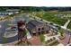 Aerial view of a vibrant City Center with a brick building, water tower, parking, and pedestrian walkways at 4915 Bergen Ct, Cumming, GA 30040