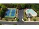 Aerial view of community amenities including a tennis court, pool, and clubhouse with ample parking at 4915 Bergen Ct, Cumming, GA 30040