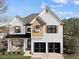 Charming two-story home featuring white painted brick, black shutters, and a well-manicured lawn at 4915 Bergen Ct, Cumming, GA 30040