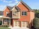 Charming two-story brick home featuring an attached two-car garage and manicured front lawn at 4915 Bergen Ct, Cumming, GA 30040