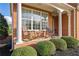 Inviting front porch with rocking chairs, perfect for enjoying the outdoors with classic brick columns at 4915 Bergen Ct, Cumming, GA 30040