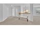 Bright upstairs hallway with carpet floors and a decorative bench at 4915 Bergen Ct, Cumming, GA 30040